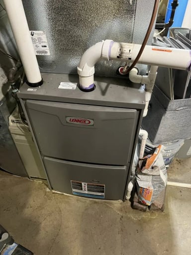 Lennox gas furnace in a residential basement setting.